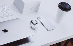 Apple laptop Apple watch Apple iPhone coffee mug on white desk