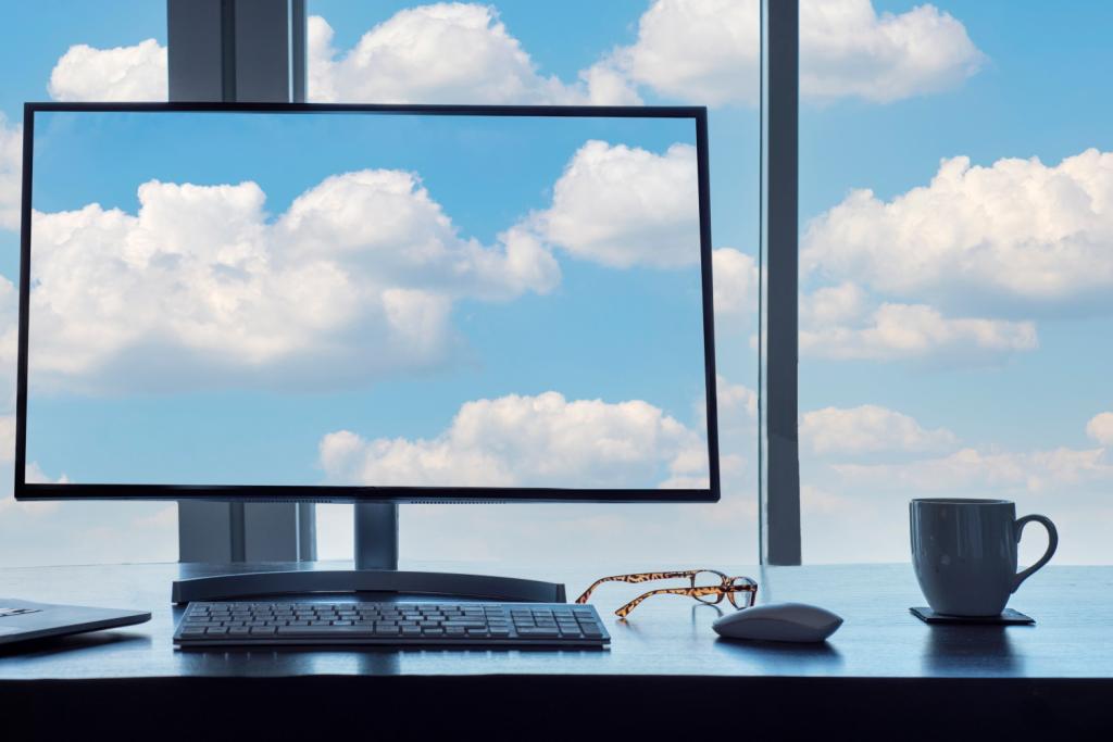 BSPOKE Softare - Clouds on a computer screen and thoruhg a window, representing hybrid cloud computing