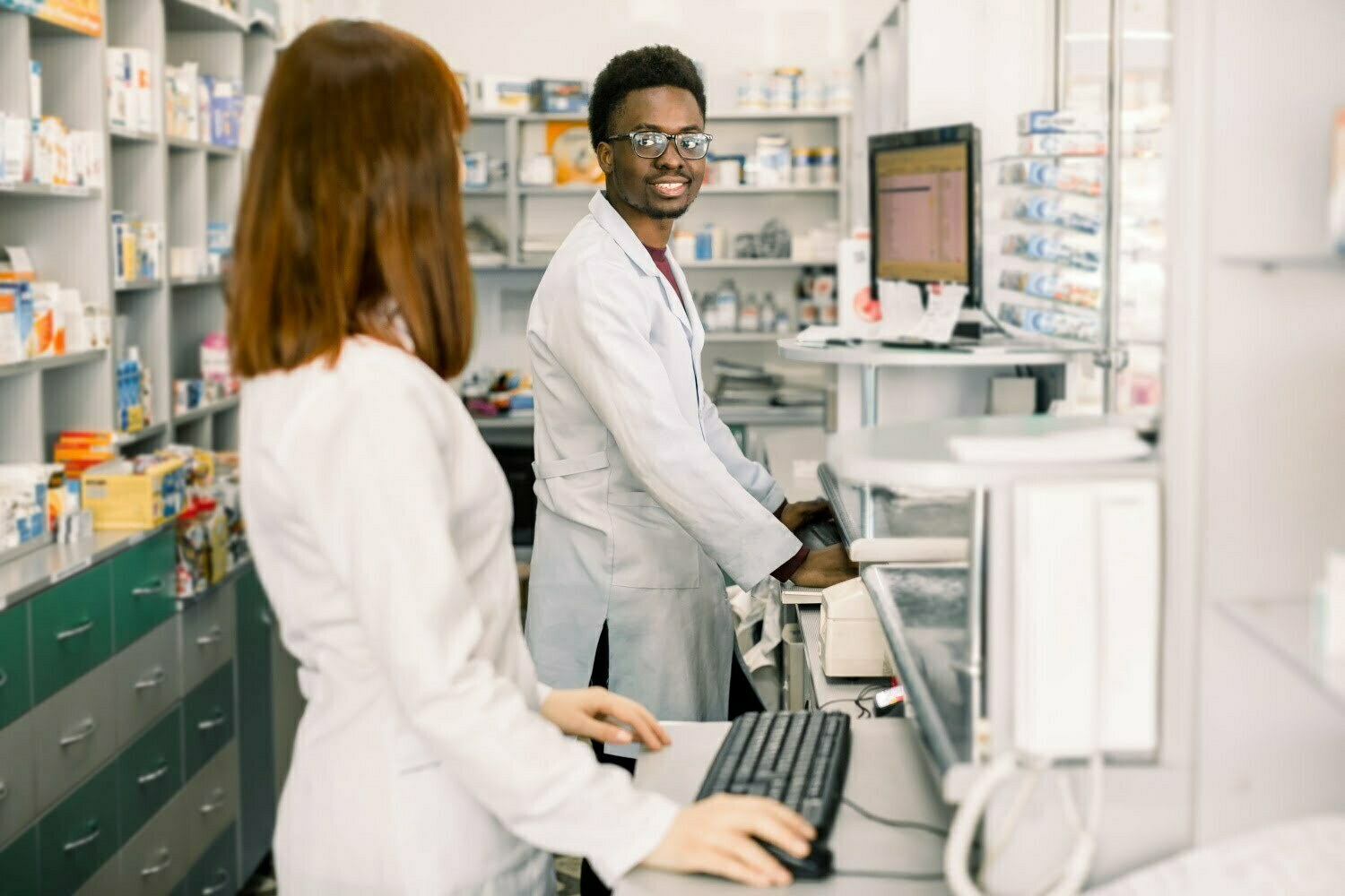 BSPOKE Software - Shows healthcare workers using a custom software system in a pharmacy