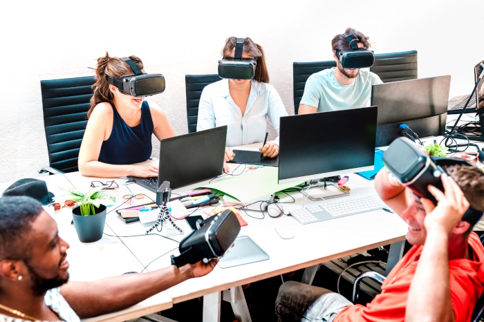 Group of office staff using VR in their digital innovative office.