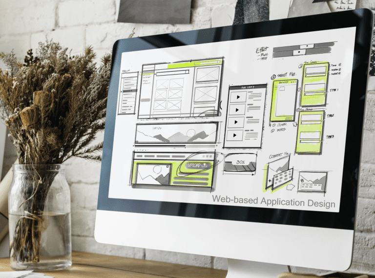 Photo of a computer monitor on the screen is a mockup of web-based application software.