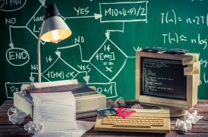 Photo of an old software system, with old computers, floppy disk etc, to represent a legacy software system.