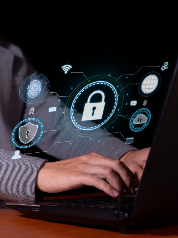 Photo of a laptop with male hands and security icons, including a lock.