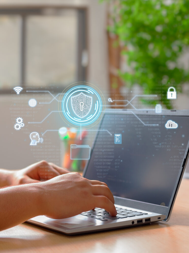 Photo of a laptop with female hands and security icons, including a lock.