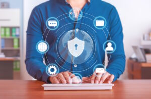 Photo of a man using a keyboard with floating icons of security to represent what is data security.