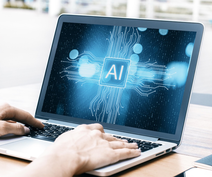 Photo of laptop with AI written on the screen.