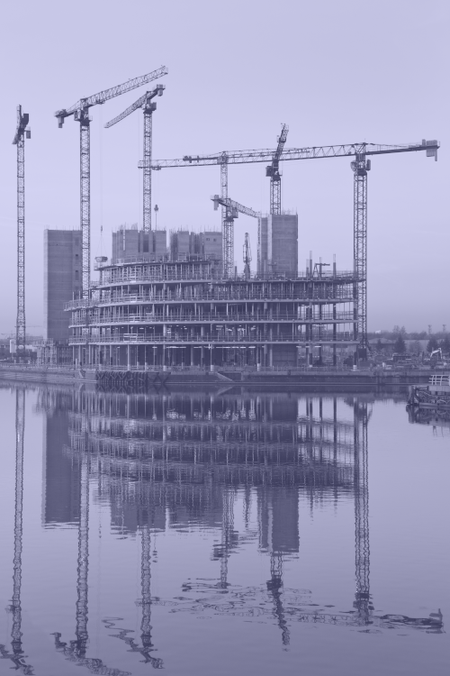 Photo of a purple tinted saturated construction site on a riverbank.