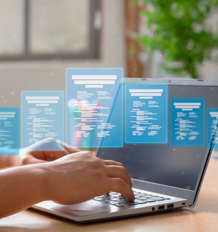 Photo of female hands on a laptop with overlaid computer views.