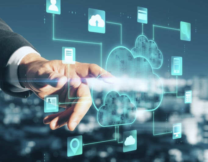 Photo of man finger pointing at an overlay of a cloud and computer icons.