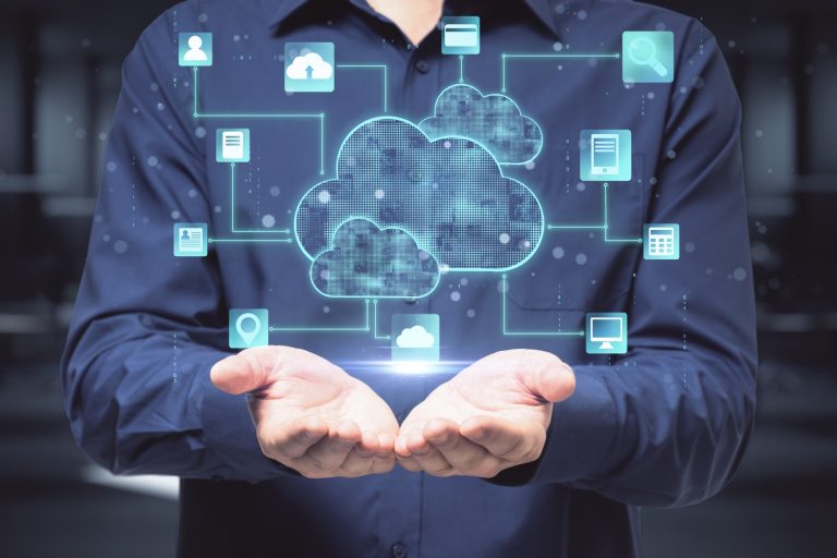 Photo of man torso and hands, with overlay of cloud and computer icons to represent managed cloud service providers.